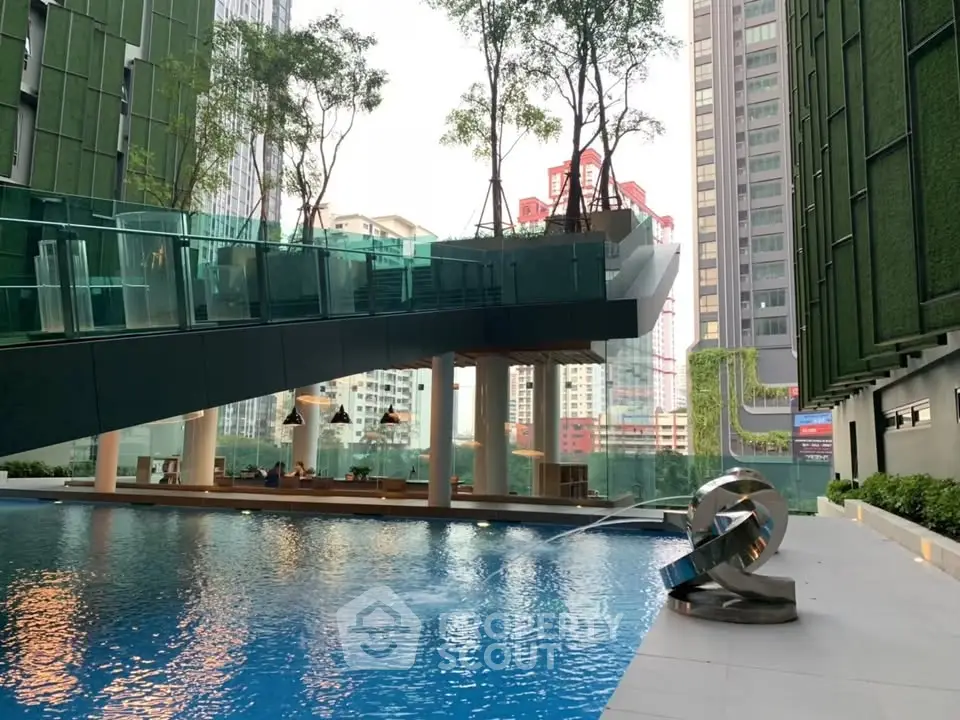 Luxurious urban pool area with modern architecture and city views.