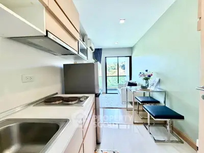 Modern open-layout kitchen and living area with natural light and scenic view.