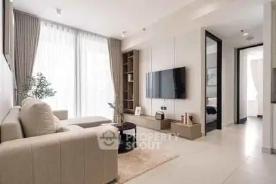 Modern living room with elegant decor and large windows in a stylish apartment.