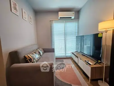 Cozy living room with modern decor, featuring a comfortable sofa, stylish TV stand, and ambient lighting.