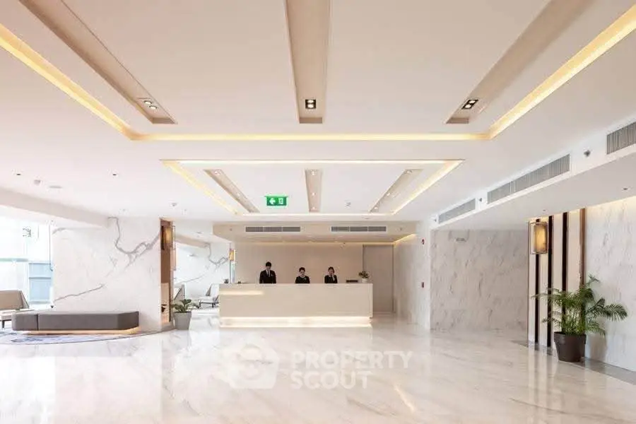 Luxurious modern lobby with marble flooring and elegant lighting, perfect for upscale living.