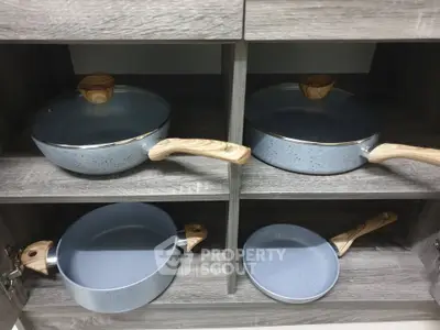Modern kitchen cabinet with stylish cookware set in sleek design