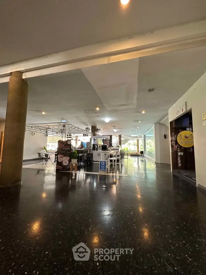 Spacious modern building entrance with sleek design and ample natural light.