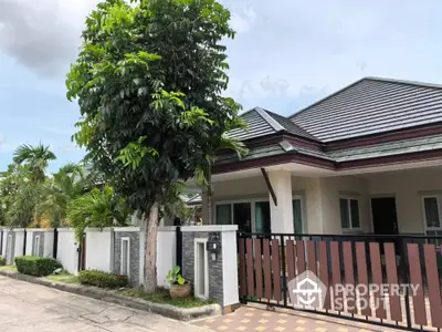 Charming single-story home with modern roof and lush garden in serene neighborhood.