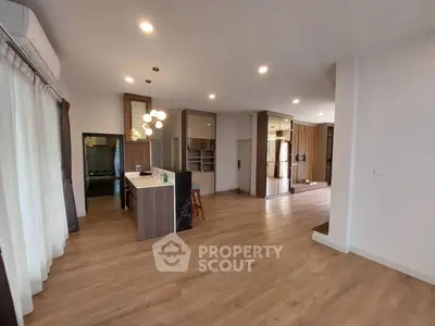 Spacious open-plan living area with modern kitchen and wooden flooring