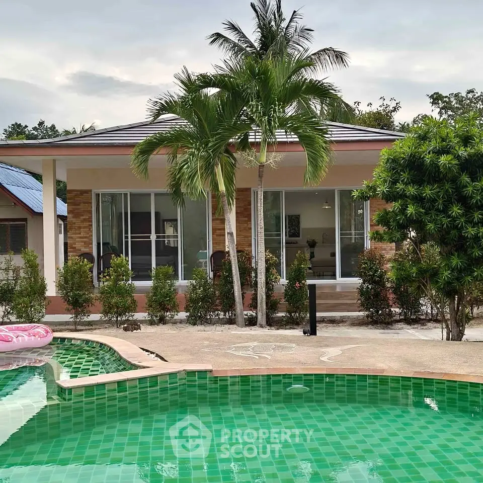 Charming tropical villa with lush garden and inviting pool, perfect for serene living.