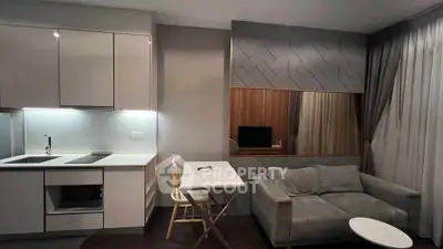 Modern apartment interior with sleek kitchen and cozy living area featuring stylish decor.