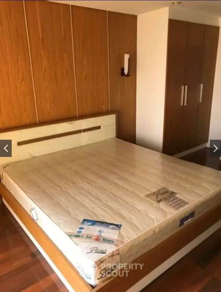 Spacious bedroom with wooden accents and built-in wardrobe