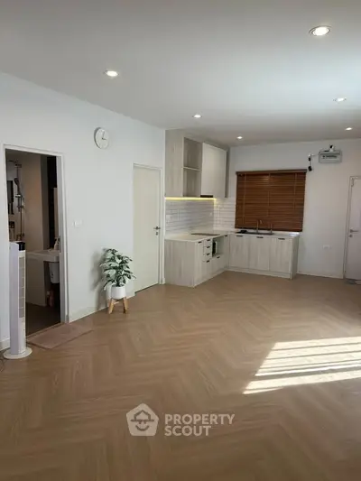 Spacious modern kitchen with open layout and elegant wooden flooring