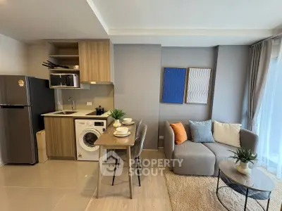 Modern open-layout kitchen and living room with stylish decor and appliances