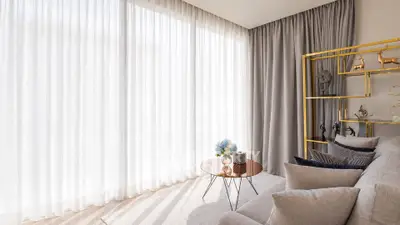 Elegant living room with floor-to-ceiling curtains and stylish decor