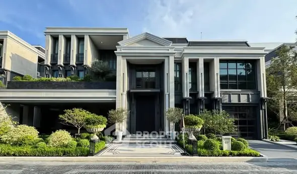 Luxurious modern mansion with grand entrance and lush landscaping