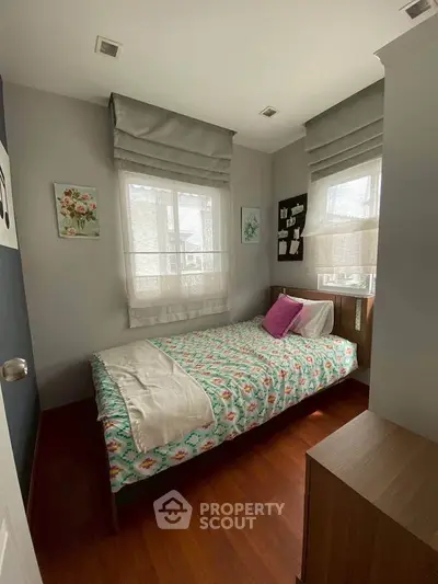 Cozy bedroom with natural light and stylish decor, perfect for relaxation and comfort.