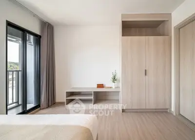 Spacious modern bedroom with balcony access and built-in wardrobe
