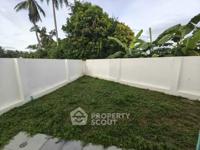 Spacious garden area with lush greenery and privacy walls, perfect for outdoor relaxation.