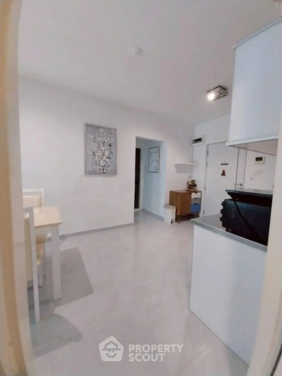 Modern open layout with sleek kitchen and dining area, perfect for contemporary living.
