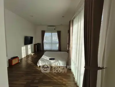 Spacious bedroom with large windows and modern decor