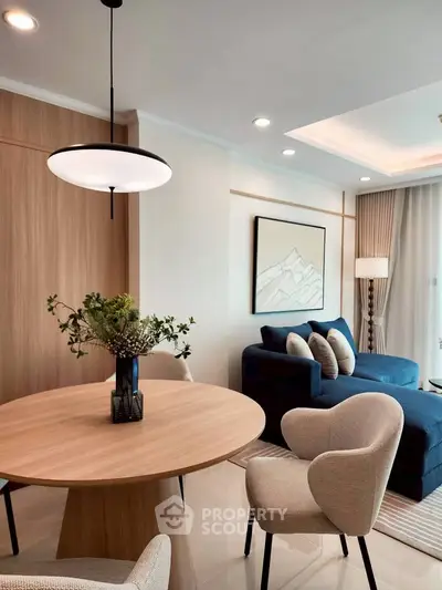 Modern living room with stylish furniture and elegant decor, featuring a cozy seating area and contemporary lighting.