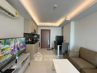 Modern living room with open kitchen, stylish furniture, and sleek appliances in a cozy apartment.