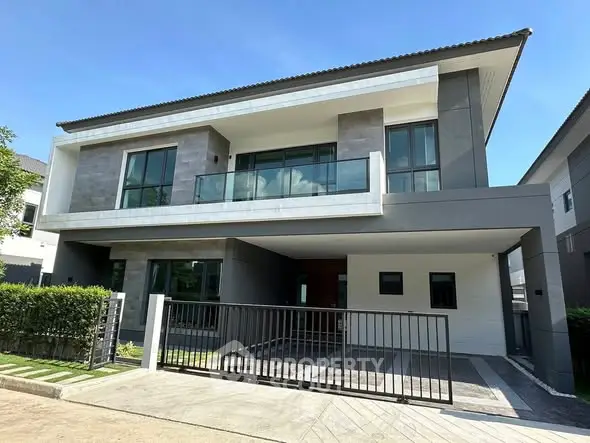 Modern two-story house with sleek design and spacious balcony in a serene neighborhood.