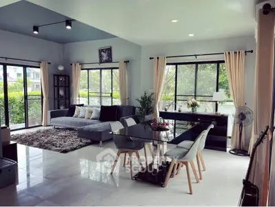 Spacious modern living room with large windows and elegant decor