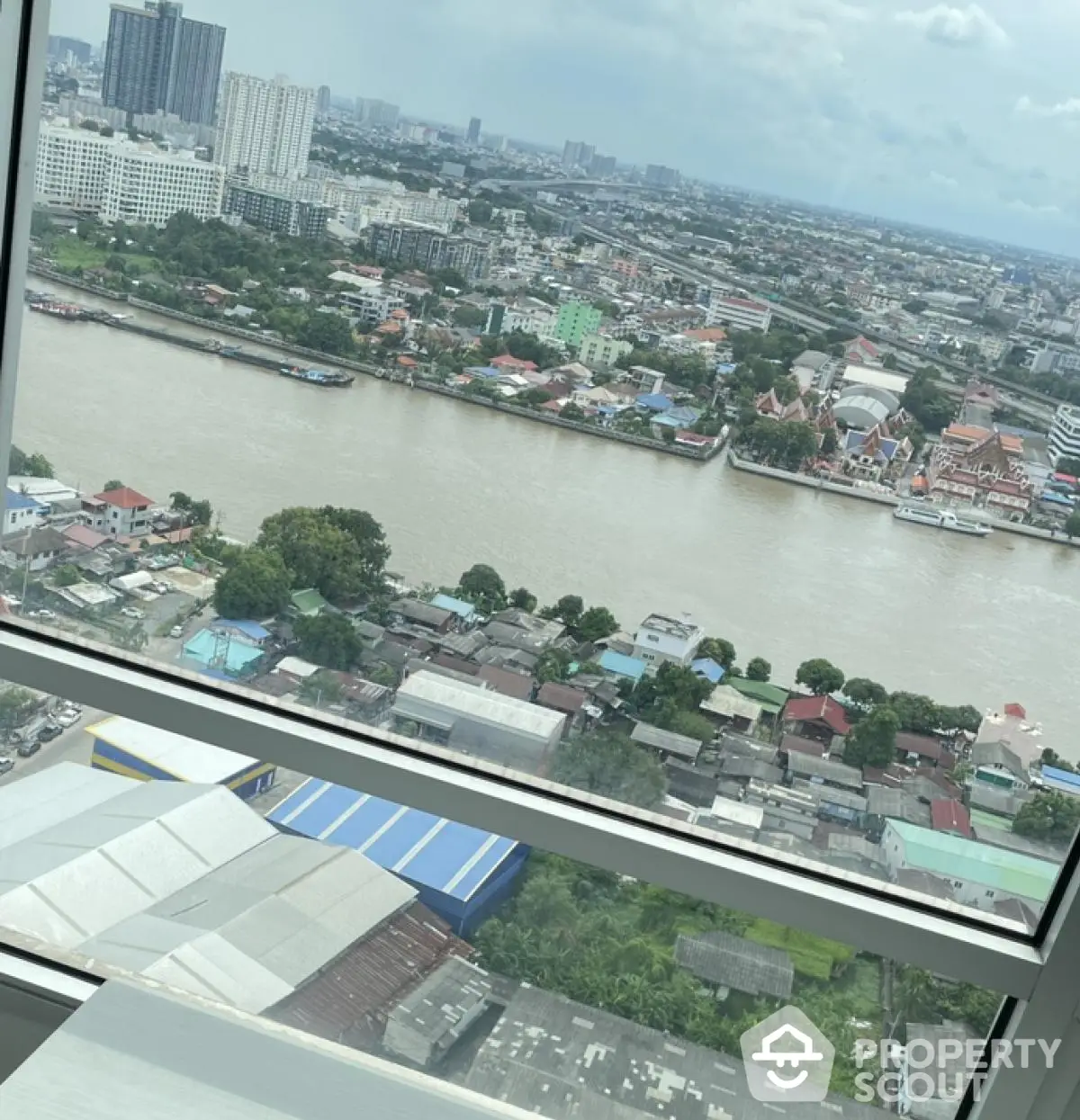 Stunning river view from high-rise apartment window in urban cityscape