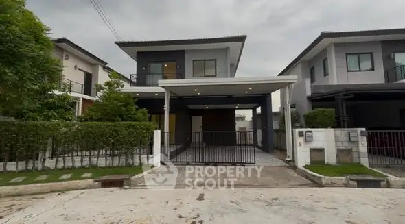 Modern two-story house with carport and landscaped front yard in suburban neighborhood.