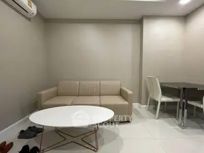 Modern living room with beige sofa and sleek dining area