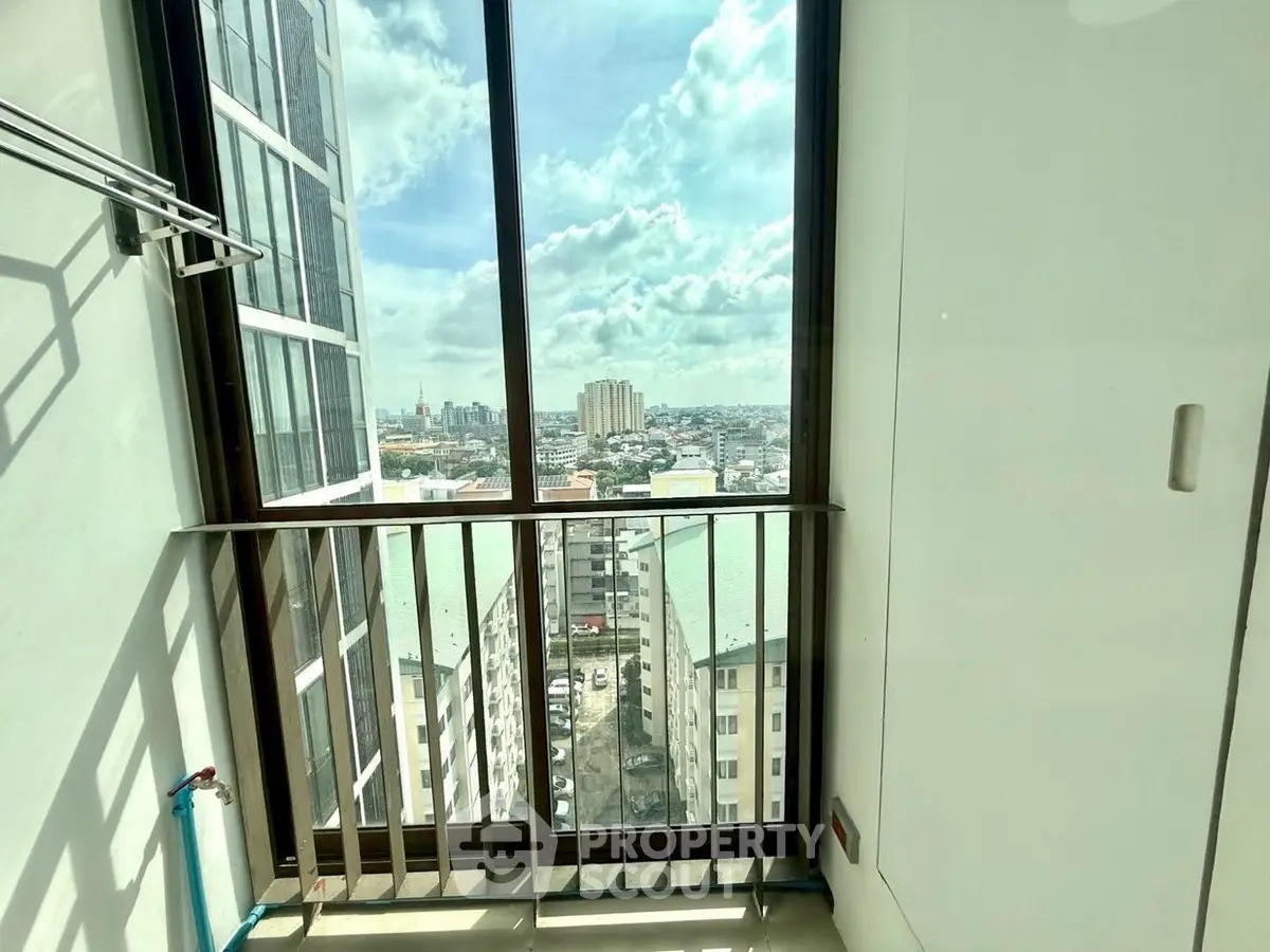 Stunning high-rise balcony with panoramic city views and ample natural light.