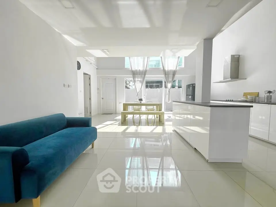 Spacious modern living room with open kitchen and elegant decor