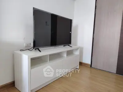 Modern living room with sleek TV stand and flat-screen television