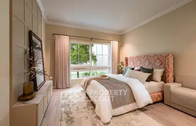 Luxurious bedroom with elegant decor and large window offering serene garden view.