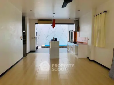 Spacious open-plan kitchen with modern design and pool view