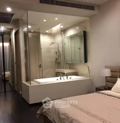 Luxurious bedroom with integrated glass-enclosed bathtub for modern living
