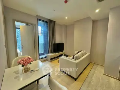 Modern living room with elegant decor and balcony view in a stylish apartment.
