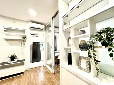Modern living room with stylish shelving and air conditioning in a cozy apartment.