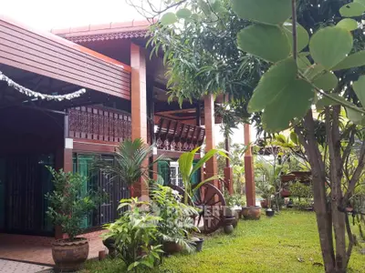 Charming tropical garden view with traditional wooden house exterior
