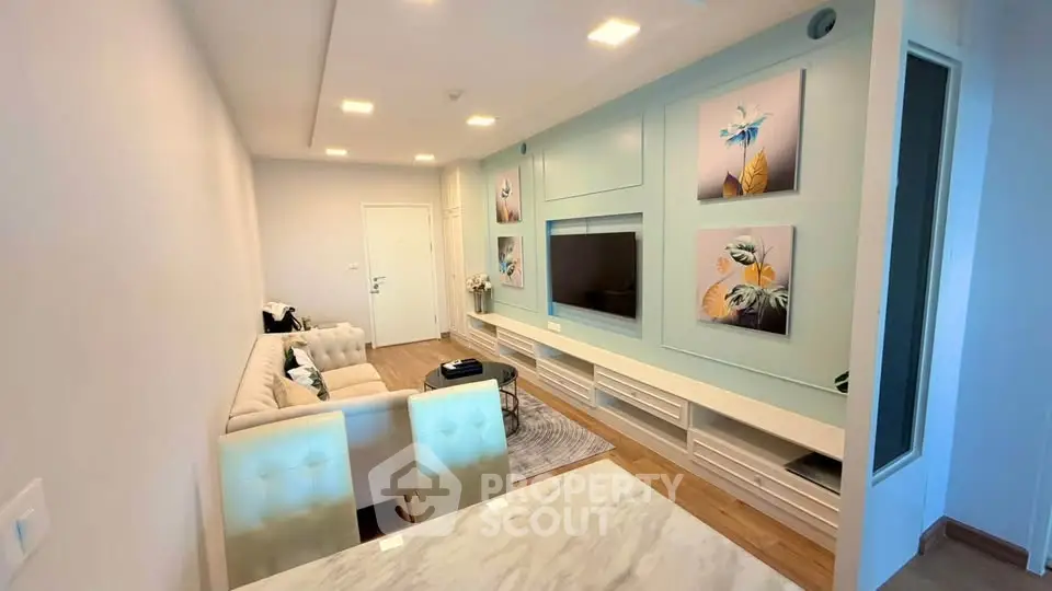 Stylish modern living room with elegant decor and built-in entertainment center.