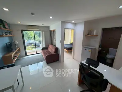 Modern open-plan living room with balcony view and stylish furniture in a bright apartment.