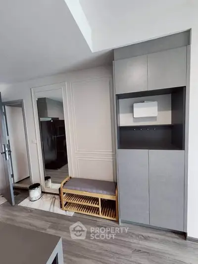 Modern entryway with sleek storage and shoe bench