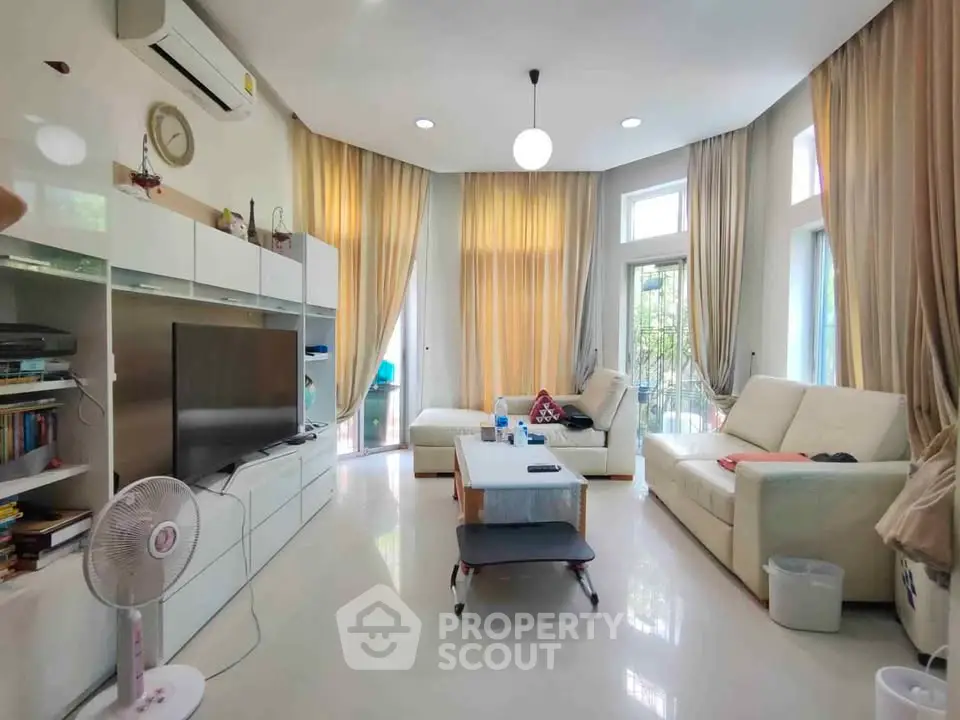 Spacious living room with modern decor and large windows for natural light