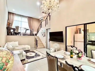 Luxurious duplex living room with elegant chandelier and modern decor