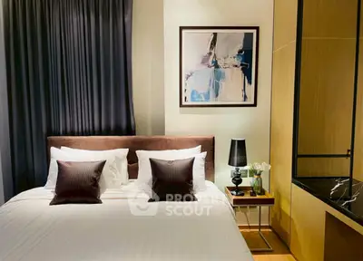 Elegant bedroom with modern decor, featuring a cozy bed, stylish artwork, and ambient lighting.