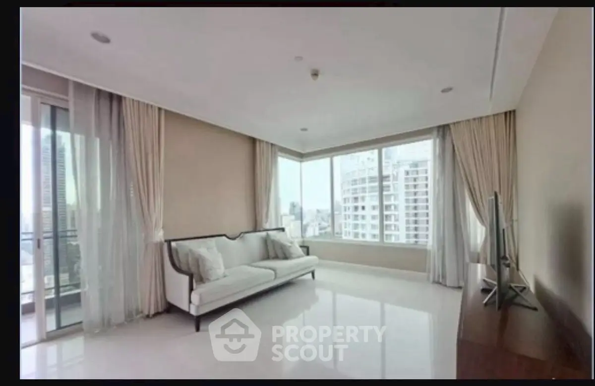 Spacious modern living room with large windows and city view
