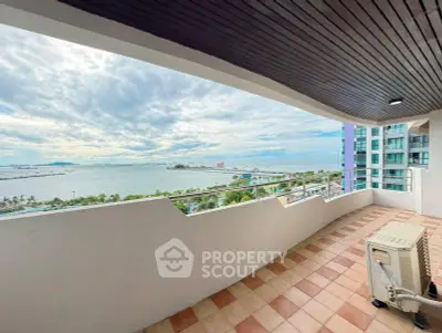 Spacious balcony with stunning ocean view in modern high-rise apartment