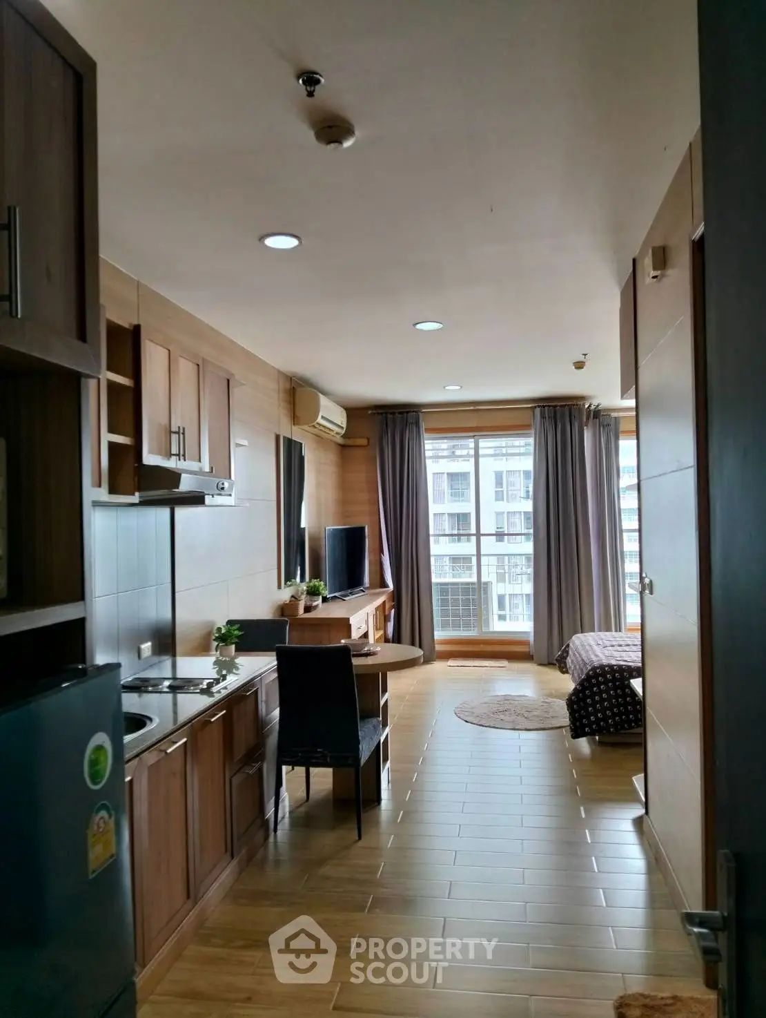 Modern studio apartment with wooden interior and city view