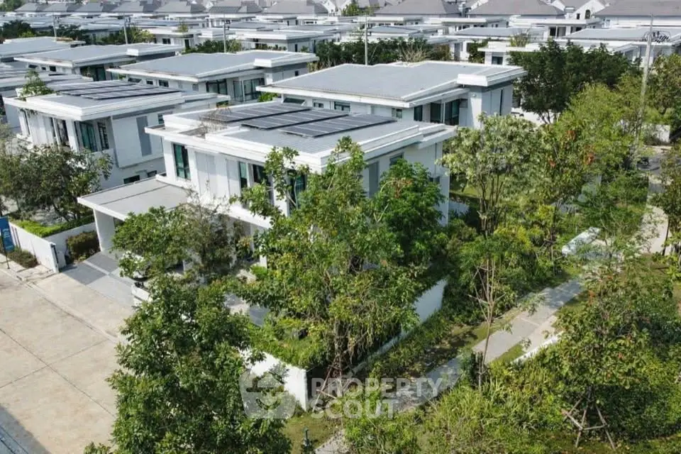 Modern residential neighborhood with contemporary houses and lush greenery.