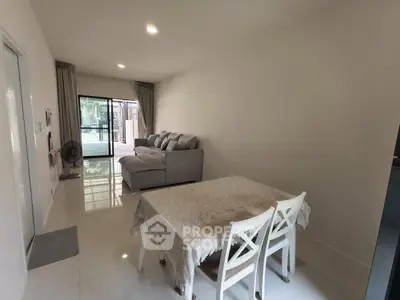 Spacious living room with modern furniture and large windows offering natural light.