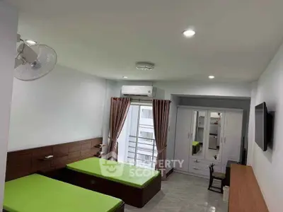 Spacious bedroom with twin beds and modern decor in a bright apartment