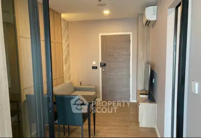 Modern living room with sleek furniture and wooden flooring in a stylish apartment.